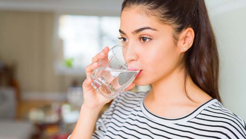 Healthy girl drinking a nice glass of water