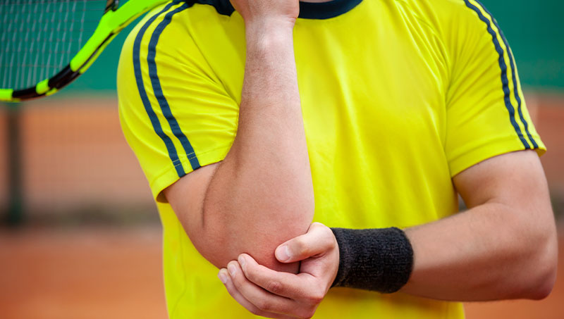 tennis player in pain from elbow injury